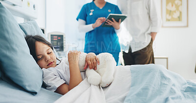 Buy stock photo Sleeping, child and girl with teddy bear, hospital and nurse with tablet for diagnosis or healthcare. Sick, kid and rest on bed with plush toy, dad and discussion with pediatric for medical report