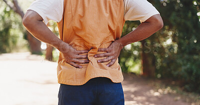 Buy stock photo Man, hands and fitness in forest with back pain, muscle spasm and hiking injury. Male person, trekking and sore in nature with exercise burnout, joint inflammation and massage to relieve tension