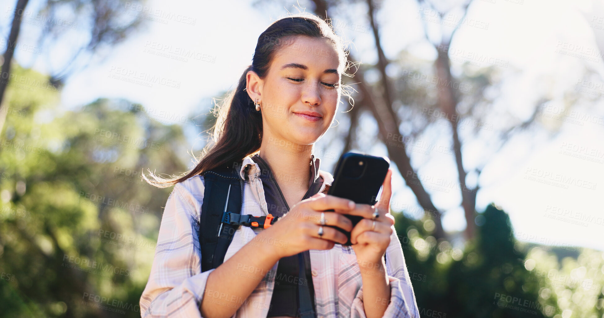 Buy stock photo Phone, navigation and woman in nature for hiking, space and guide in path direction. Travel, bokeh and female person in forest with tech, map tracking and location search on outdoor adventure.
