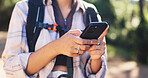 Hike, chat or hands in forest with phone, message alert or location share in summer hobby. Trekking, bokeh or female person in nature with tech, notification check or journey update on social media.