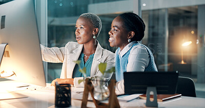 Buy stock photo Night, business people and planning in office with computer, discussion and deadline for audit review. Late, black women and talk in workplace with desktop, finance report and advice for accounting.