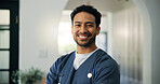 Man, doctor and happy in portrait at clinic with pride, confident or service for wellness in lobby. Person, medical professional and surgeon with smile, healthcare and career at hospital in Indonesia
