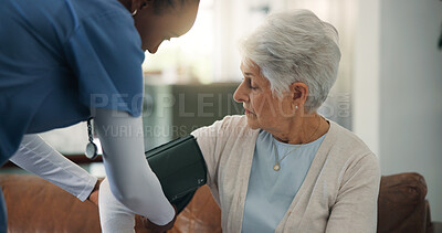 Buy stock photo Blood pressure, consulting or medical with old woman and nurse on sofa for help or home appointment. Arm cuff, bp monitor or healthcare and caregiver with senior patient in apartment for checkup