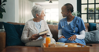 Buy stock photo Smile, nurse and old woman with book in home for homecare, support and healthcare at breakfast. Caregiver, elderly person and literature in house, medical wellness and relax with novel in retirement