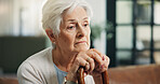 Senior woman, thinking and sofa with cane for nostalgia, past event or old memory in home. Sad elderly, female person or thoughtful thinker with walking stick, regret or grief for medical condition