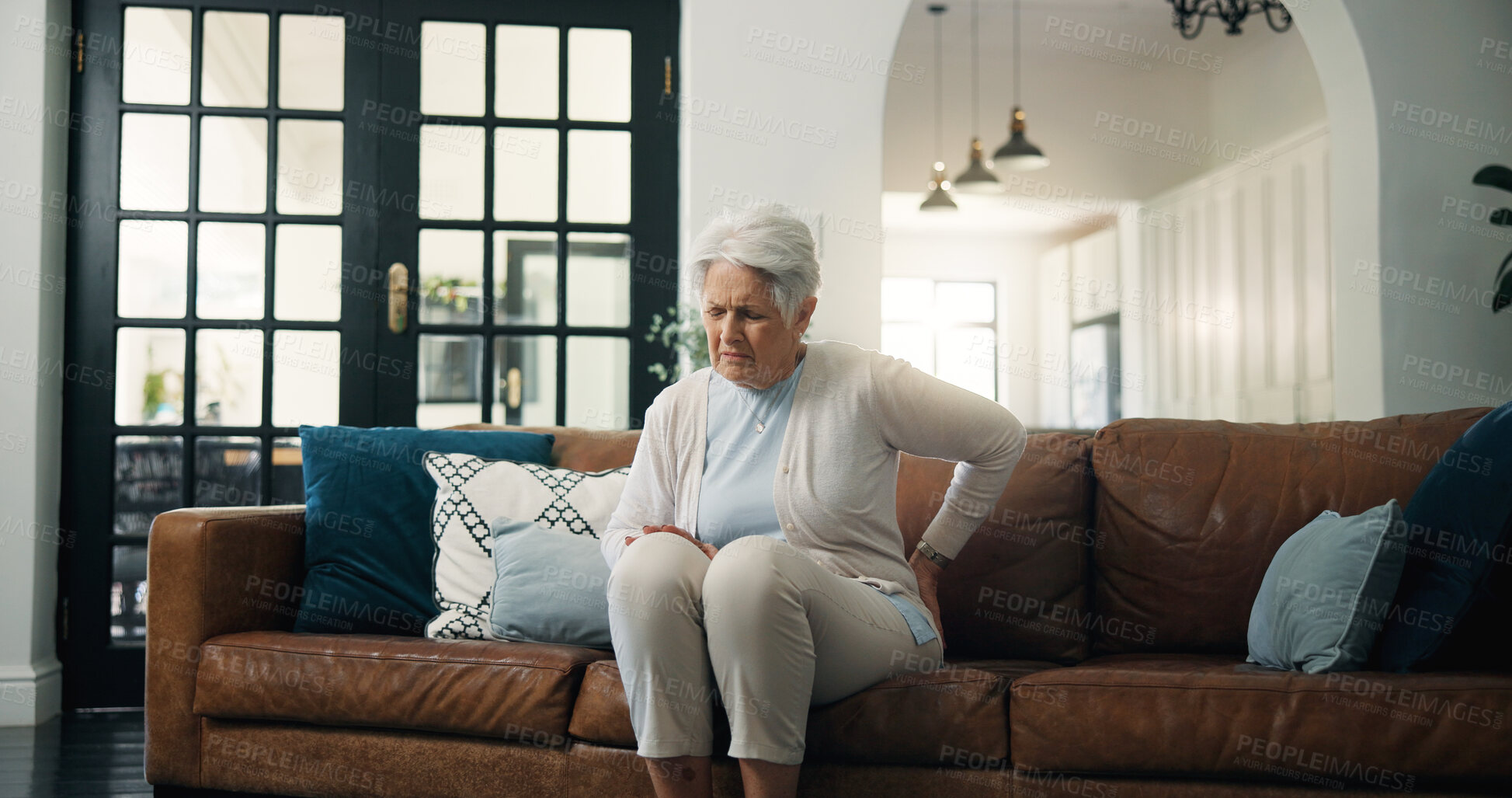 Buy stock photo Upset, old woman and back pain in home with arthritis, osteoporosis and fatigue from medical problem. Elderly person, spine injury and hurt in living room with fibromyalgia, muscle tension and issue.
