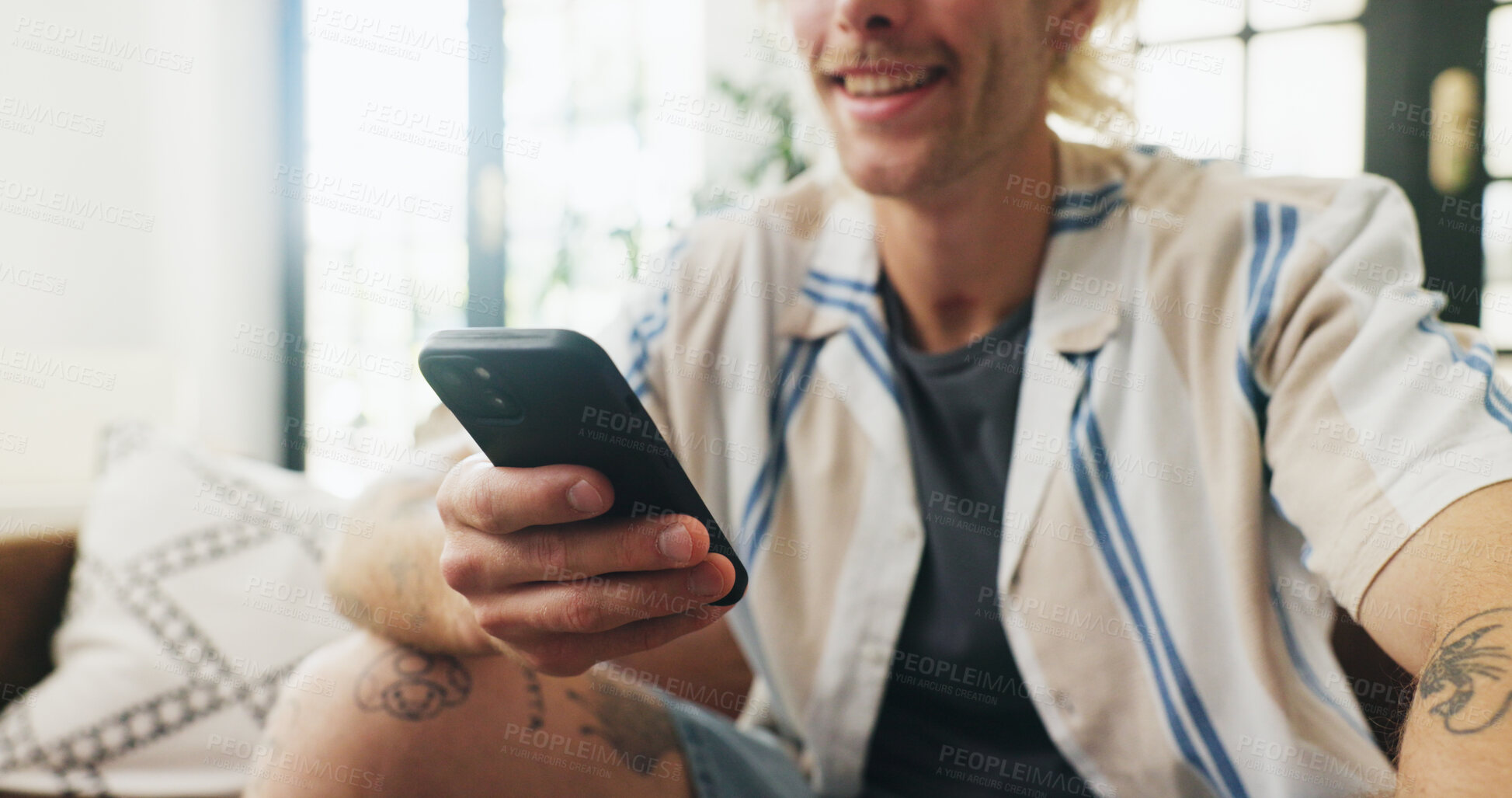 Buy stock photo Phone, hands and man on sofa in home with networking, communication or chatting on mobile app. Relax, smile and male person with cellphone for online texting, blog or contact in living room at house.