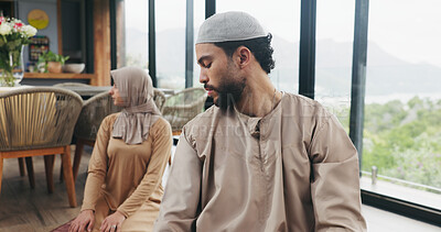 Buy stock photo Muslim couple, house and prayer to praise Allah, spiritual faith or devotion for religion on Eid. Islamic, man and woman praying together for tasleem, salah or worship God with partner in living room