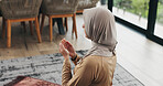 Back, woman and praying with dua at house for faith, praise Allah and spiritual worship in Ramadan. Muslim, person and prayer with salah, religious practice and devotion to God for islamic belief
