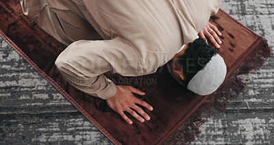 Buy stock photo Muslim, man and prayer with bow for faith, religion and dua on Ramadan Kareem above in home. Islam, praying and person worship God with spiritual devotion, salah and praise Allah on mat in house
