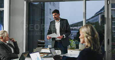 Buy stock photo Man, documents and presentation at office meeting with team, insight and review at investment company. Person, advisor or broker with paperwork, evening and feedback with asset management at agency