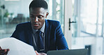 Finance, review or analyst in office with paper, funding check or data analysis for budget pitch. Research, paperwork and black man with laptop, profit report or proposal update for investment plan.
