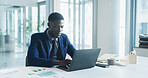 Business, laptop and typing with black man in office for review of corporate or financial data. Computer, finance graphs and report with African employee at desk in workplace for planning or research