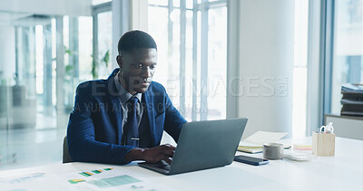 Buy stock photo Business, laptop and typing with black man in office for review of corporate or financial data. Computer, finance graphs and report with African employee at desk in workplace for planning or research