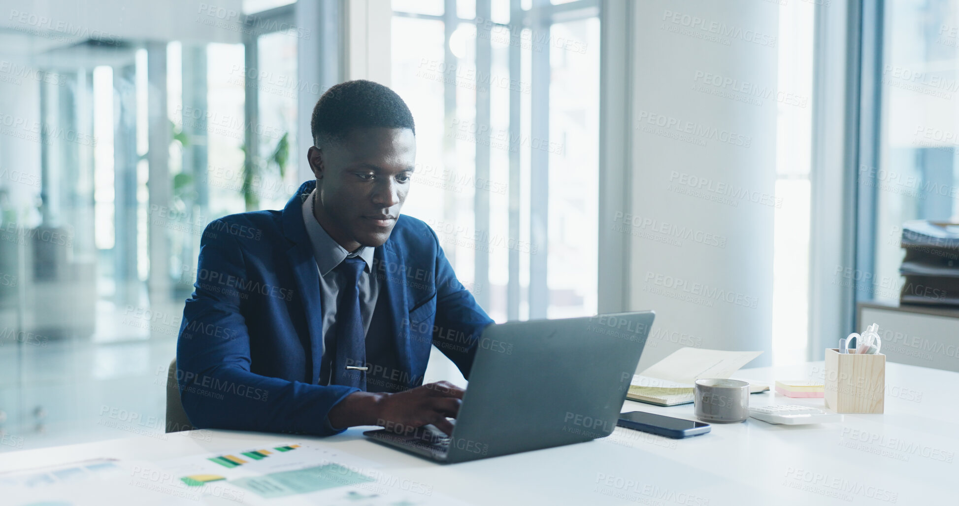 Buy stock photo Business, laptop and typing with black man in office for review of corporate or financial data. Computer, finance graphs and report with African employee at desk in workplace for planning or research