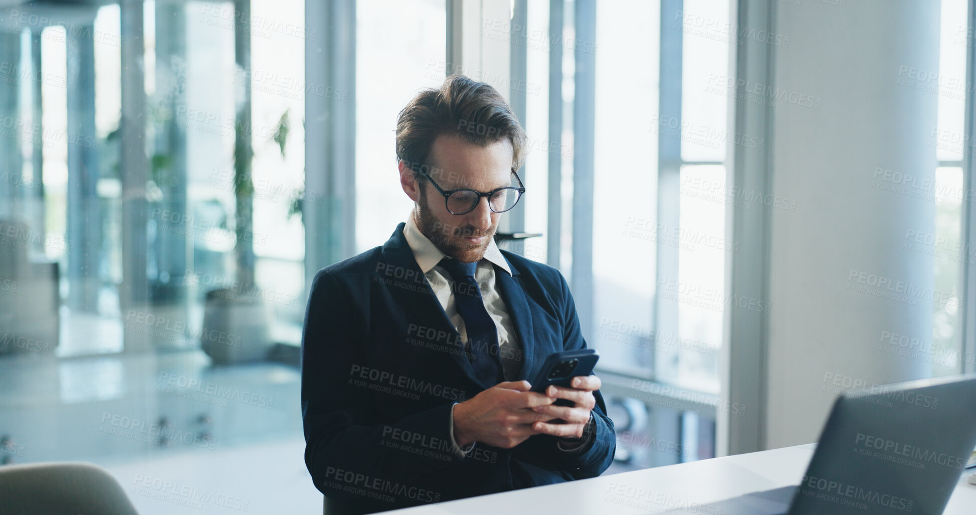 Buy stock photo Business, laptop and phone with man in office for communication, corporate finance or update. Computer, text message and typing with employee at desk in financial workplace for mobile feedback