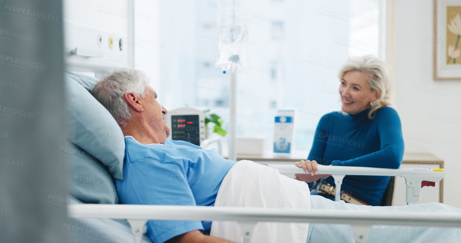 Buy stock photo Old couple, smile and conversation by hospital bed for support, compassion or empathy for recovery. Married, elderly people and happy in medical clinic with care, chat or good news for health update.