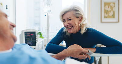 Buy stock photo Happy, old couple and holding hands by hospital bed with support, kindness or empathy for recovery. Married, elderly people and smile in medical clinic with care, chat or good news for health update.