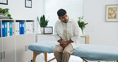 Buy stock photo Appointment, healthcare and pain with man in hospital for checkup, discomfort or pressure. Bladder infection, inflammation and medical with patient waiting on bed in clinic for diagnosis or exam