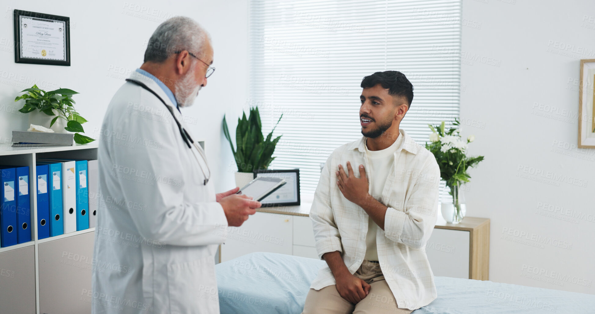 Buy stock photo Doctor, chest pain and consultation with tablet, healthcare symptoms or heart assessment in clinic. Sick man, medical worker and patient with breathing problem, lung checkup or cardiology with tech