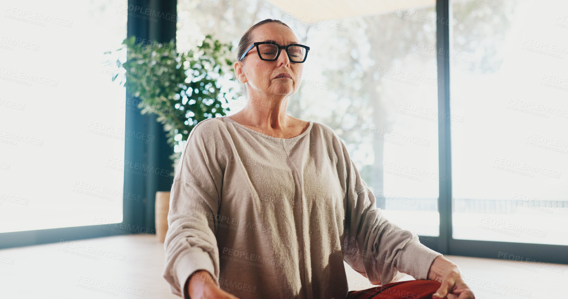 Buy stock photo Yoga, woman and calm with meditation in studio for holistic wellness, spiritual healing or inner peace. Zen, mature female person or breathing on floor for mental health, mindfulness or stress relief