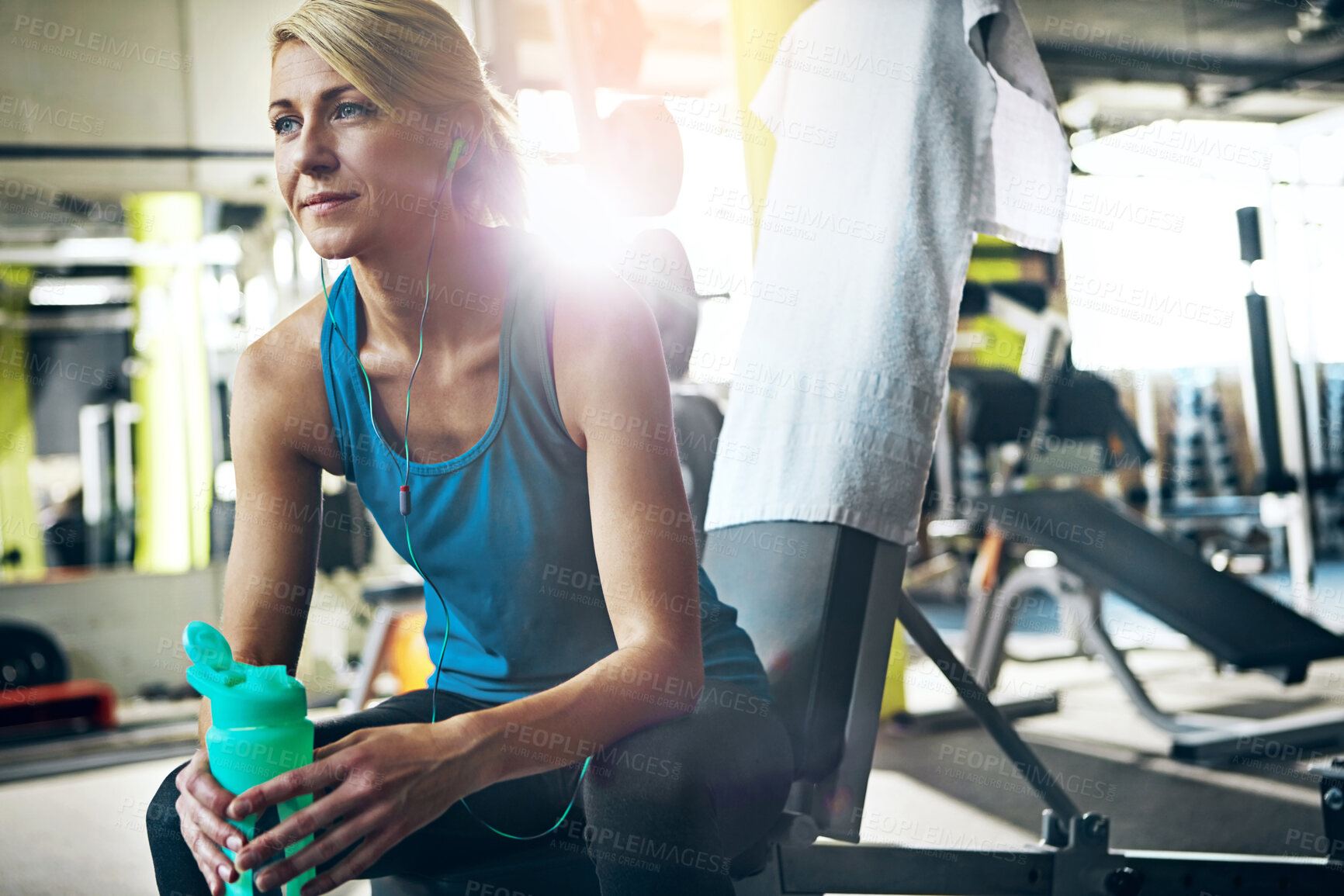Buy stock photo Thinking, woman and break with earphones in gym for fitness recovery, workout pause and water. Flare, athlete and relax with music playlist at health club for exercise rest and contemplating training