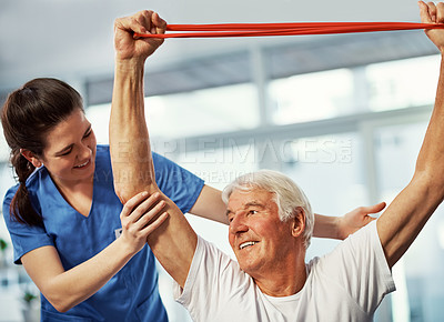 Buy stock photo Physiotherapy, old man and stretching in clinic with resistance band, trust and support for mobility. Happy, senior person and healthcare worker with physical therapy, assistance and rehabilitation.