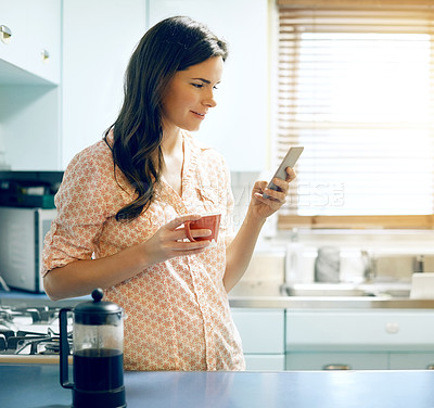 Buy stock photo Woman, phone and coffee with texting in home with smile, contact and online dating in kitchen. Person, happy and smartphone with drink, beverage and mobile app with chat on social media at house