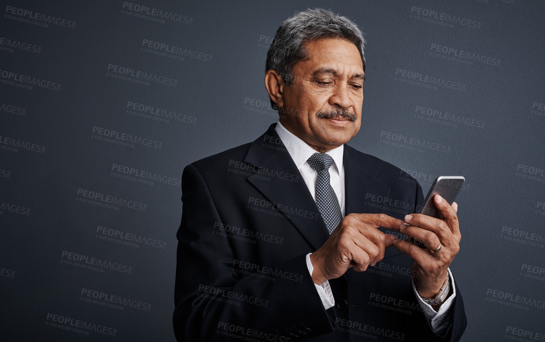 Buy stock photo Mature, businessman and scrolling with phone in studio for social media on a gray background. Man, employee or user with mobile smartphone or research for online app, texting or connection on space