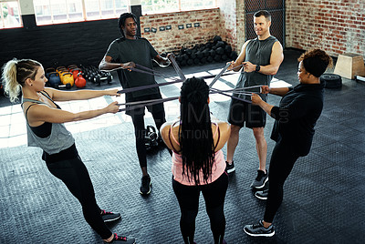 Buy stock photo Resistance band, gym and people in circle for exercise, stretching and workout routine. Personal trainer, fitness club and women with elastic for muscle strength, training and challenge for wellness