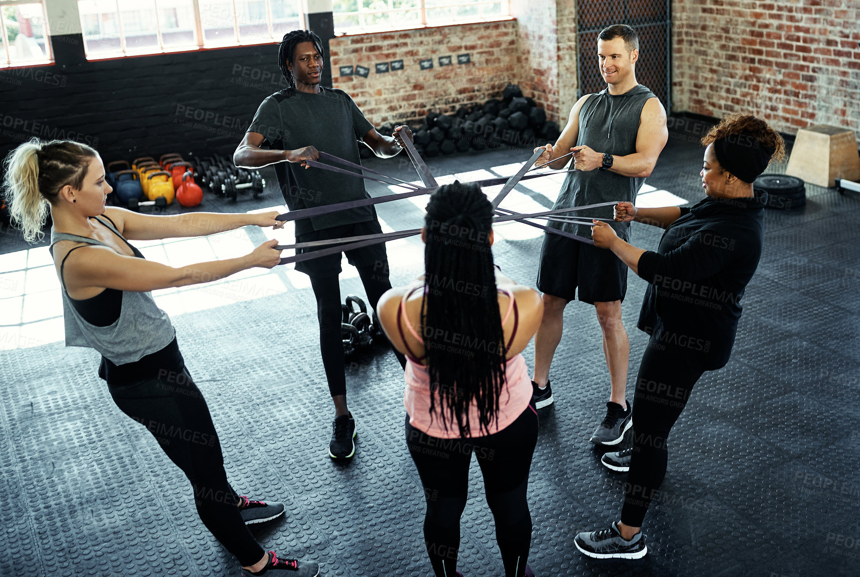 Buy stock photo Resistance band, gym and people in circle for exercise, stretching and workout routine. Personal trainer, fitness club and women with elastic for muscle strength, training and challenge for wellness