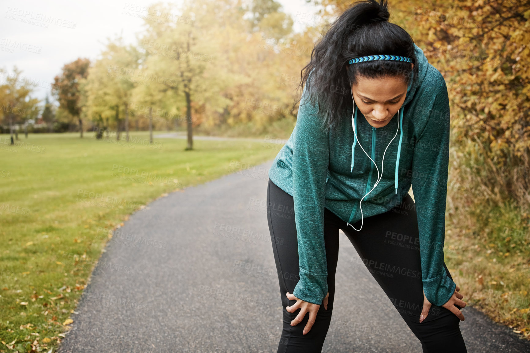 Buy stock photo Earphones, outdoor and tired woman with fitness break, endurance training or cardio workout for fatigue. Rest, exhausted or athlete with audio tech for exercise, countryside or running for body goals
