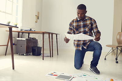 Buy stock photo Marketing, review or black man on floor with paper, data or visuals in campaign planning. Brainstorming, check or branding clerk in office with stats, proposal insight or ideas for creative report.