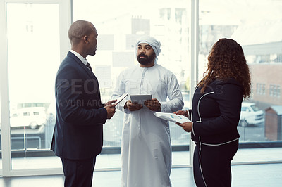 Buy stock photo Meeting, team and tablet with business people in office for trading workshop, planning or b2b advisor. Partner, employees and online portfolio manager with Middle east representative at expo in Qatar