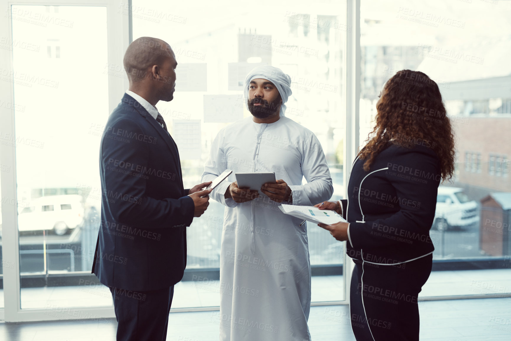 Buy stock photo Meeting, team and tablet with business people in office for trading workshop, planning or b2b advisor. Partner, employees and online portfolio manager with Middle east representative at expo in Qatar