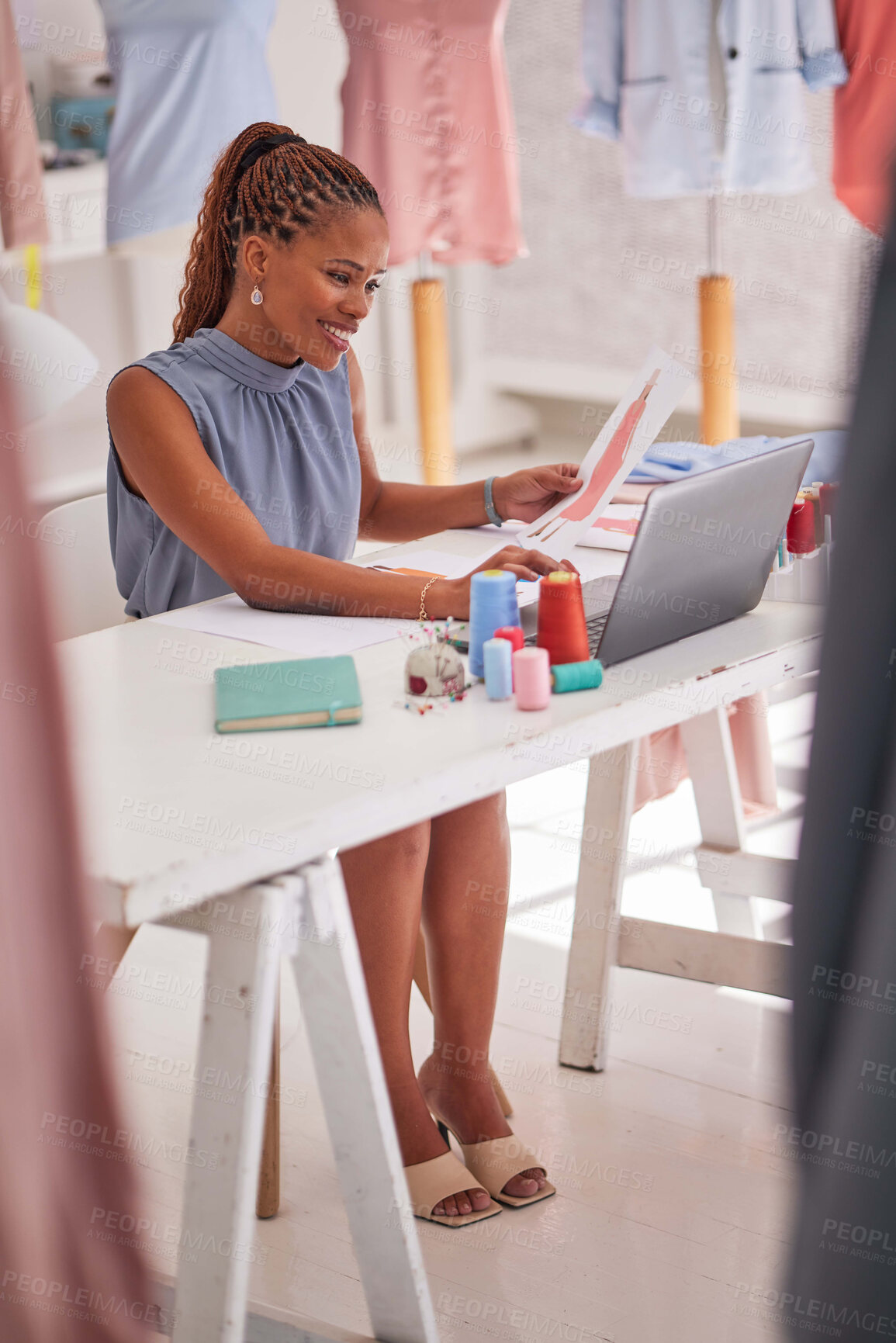 Buy stock photo Black woman, laptop and planning in design for fashion, stylist or working at the workshop. Female small business owner or designer in creative strategy or checking textile inventory online at office