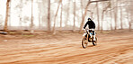Motorcycle, speed and space with a sports man in the forest for adrenaline while dirt biking. Bike, training and power with a person driving fast on an off road course for freedom or performance