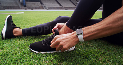 Buy stock photo Hands, shoes and tie with person on field in stadium for start of cardio training, fitness or workout. Exercise, laces and sneakers with runner getting ready for competition or sports in arena