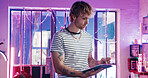 Drawing, neon and tablet with man in tattoo parlor for artistic design or creative planning. App, pen and small business with designer person in studio for ink or process of body art development