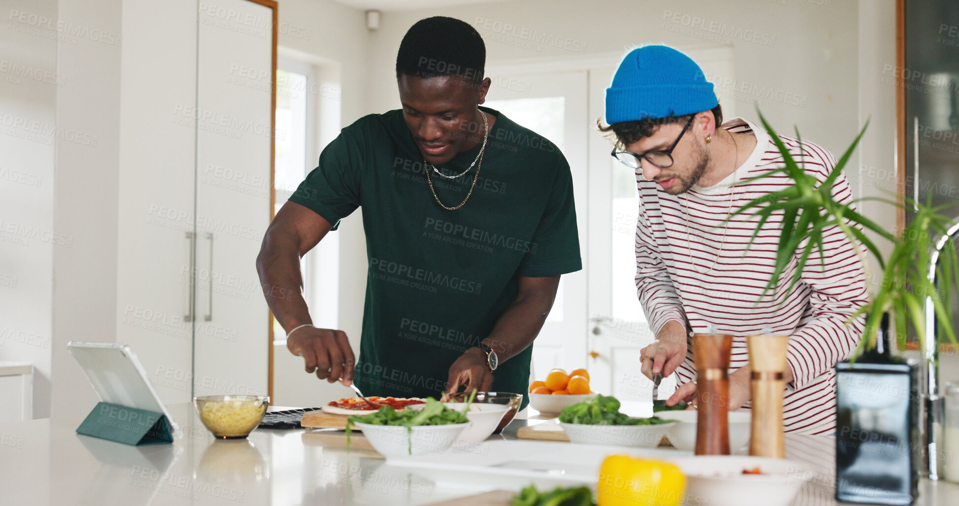 Buy stock photo Cooking, food and pizza with people in kitchen of home together to follow online recipe tutorial. App, tablet and video instructions with roommate friends at counter in apartment for meal preparation
