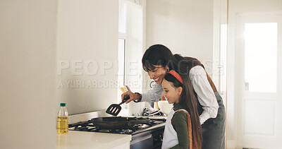 Buy stock photo Cooking, learning or spatula with mom and daughter in kitchen of home for bonding or development. Pan, stove or teaching with girl child and single parent woman in apartment for recipe instructions