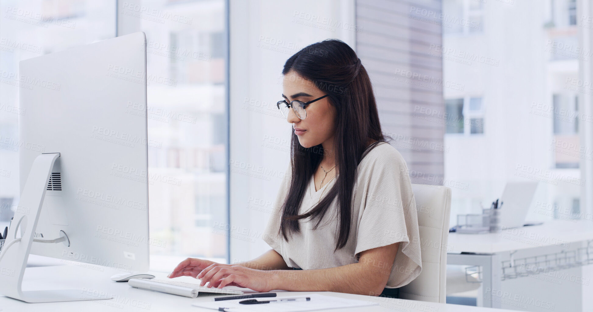 Buy stock photo Creative, woman and typing in agency with computer, research story and news report for journalism. Person, glasses and browsing in office with desktop, plan and editing article for media publication.