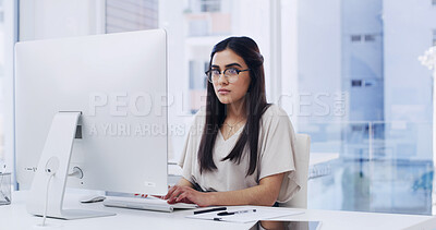 Buy stock photo Creative, woman and browsing in agency with computer, typing news report and story for journalism. Person, glasses and research in office with desktop, plan and editing article for media publication.