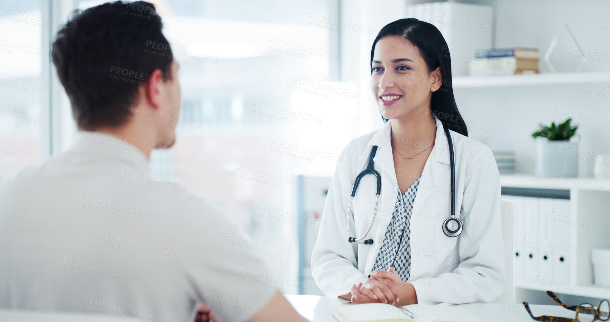 Buy stock photo Talking, office and doctor with man for consultation, medical service and advice for treatment plan. Healthcare, happy and woman with patient in clinic for appointment, checkup and help for wellness