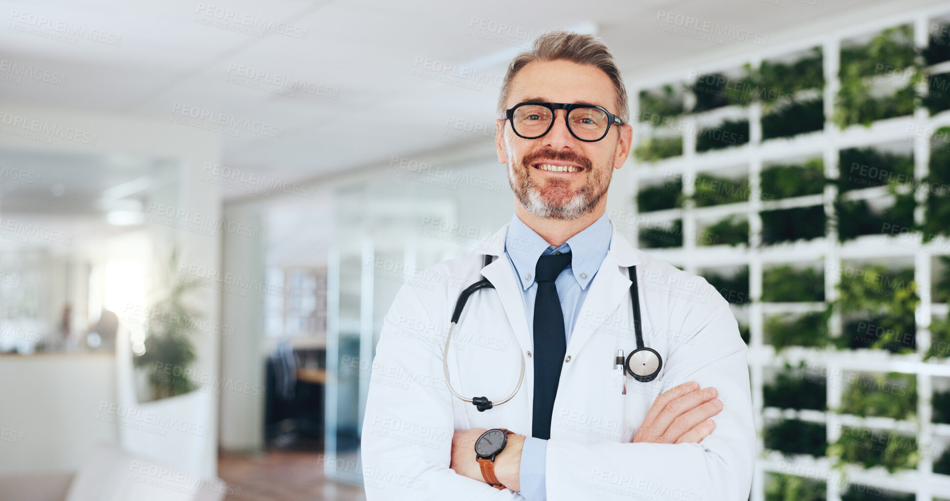 Buy stock photo Doctor, man and happy with arms crossed in clinic for medical service, career pride and about us. Cardiologist, mature person and healthcare portrait in hospital for health integrity and experience