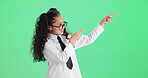 Advertising, green screen and pointing with girl child in studio for announcement, news or notification. Gesture, glasses and marketing with female kid isolated on mockup space for update message