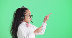 Girl, consultant and pointing with headset in studio for call center cosplay on a green background. Child, kid agent or junior consultant with online advertising for role play or pretend on space