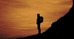 Sunset, trekking and silhouette of man on mountain for adventure, reflection and vacation with view. Hiking, backpacking and person outdoor for holiday, travel or thinking with space for sightseeing