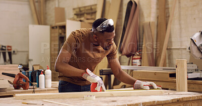 Buy stock photo Carpentry, planning and black man with tape measure in workshop, construction process and precision. Tools, woodworking and carpenter with plank for creative project, material preparation and craft