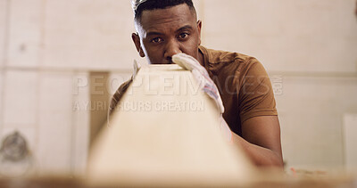 Buy stock photo Carpenter, man and inspection in workshop with woodwork, remodeling project or furniture production. Black person, check timber or quality control with craftsmanship, carpentry or manufacturing plan.